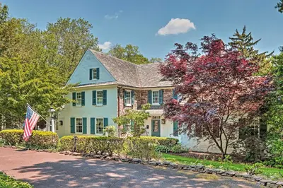 a house with an american flag in the driveway at Pool and Courtyard Timeless Home in Lansdale in Lansdale