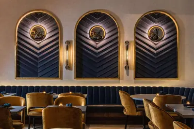 a restaurant with chairs and tables and windows at Motto by Hilton New York City Chelsea in New York