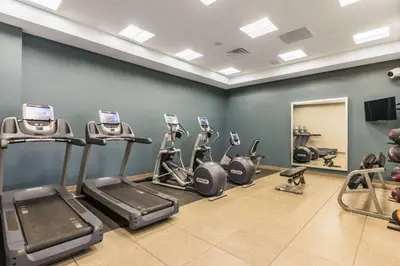 a gym with treadmills and ellipticals in a room at Embassy Suites by Hilton Newark Airport in Elizabeth