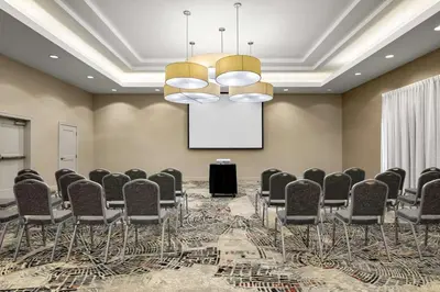 a conference room with chairs and a projection screen at Embassy Suites by Hilton Newark Airport in Elizabeth