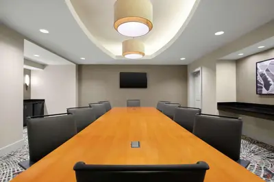 a conference room with a long table and chairs at Embassy Suites by Hilton Newark Airport in Elizabeth