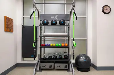 a gym with a rack of balls and weights at Embassy Suites by Hilton Newark Airport in Elizabeth