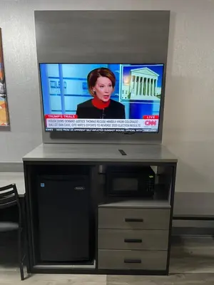 a flat screen tv sitting on top of a entertainment center at The Wayne Inn in Wayne
