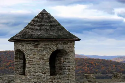 a stone tower with a roof on top of a mountain at Crystal Springs Inn and Suites in Towanda