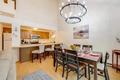 a kitchen and dining room with a table and chairs at Near Skiing and Lakes Contemporary Poconos Townhome in Lake Harmony