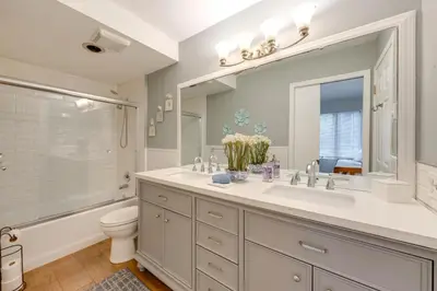 a bathroom with a sink and a toilet and a mirror at Near Skiing and Lakes Contemporary Poconos Townhome in Lake Harmony