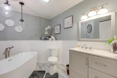a bathroom with a tub and a toilet and a sink at Near Skiing and Lakes Contemporary Poconos Townhome in Lake Harmony