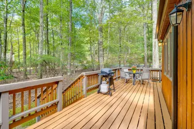 a wooden deck with a grill and a picnic table on it at Near Skiing and Lakes Contemporary Poconos Townhome in Lake Harmony
