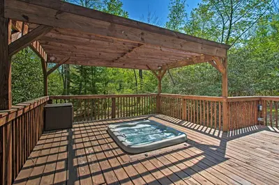 a gazebo with a hot tub on a deck at Fire Pit and Hot Tub Poconos Family Cabin! in Long Pond