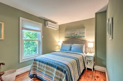 a bedroom with a bed and a window at Charming Abode with Patio - Walk to Town and River! in Stockton
