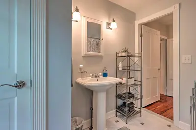 a bathroom with a white sink and a shelf at Charming Abode with Patio - Walk to Town and River! in Stockton