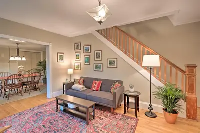 a living room with a couch and a table at Charming Abode with Patio - Walk to Town and River! in Stockton