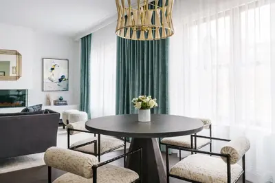 a dining room with a table and chairs in a room at The Wallace Hotel in New York