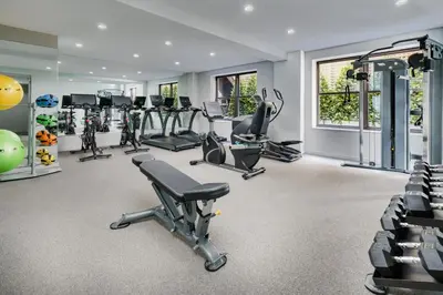a gym with treadmills ellipticals and exercise bikes at The Wallace Hotel in New York