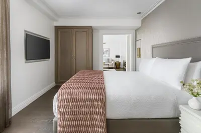 a hotel room with a bed and a flat screen tv at The Wallace Hotel in New York