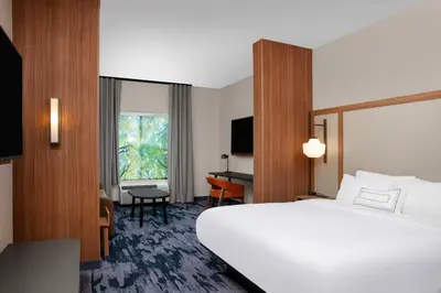 a hotel room with a large bed and a desk at Fairfield by Marriott Inn & Suites Lewisburg in Lewisburg