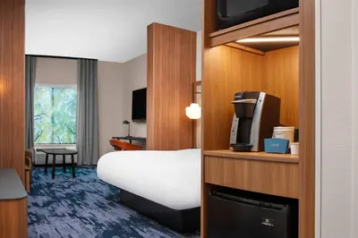 a hotel room with a bed and a television at Fairfield by Marriott Inn & Suites Lewisburg in Lewisburg