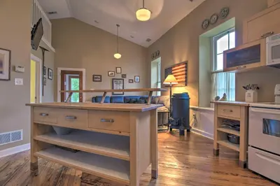 a kitchen with a large island in the middle of a room at Private Hot Tub at Cozy Wrightsville Cottage! in Wrightsville