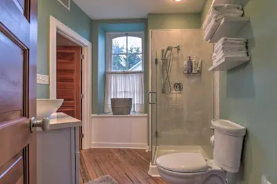 a bathroom with a shower and a toilet and a sink at Private Hot Tub at Cozy Wrightsville Cottage! in Wrightsville