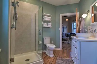 a bathroom with a shower and a toilet and a sink at Private Hot Tub at Cozy Wrightsville Cottage! in Wrightsville