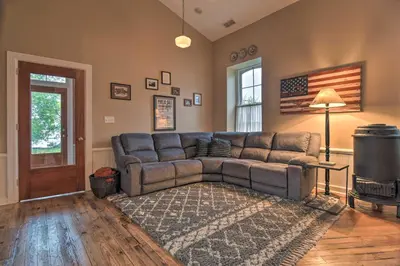 a living room with a couch and an american flag at Private Hot Tub at Cozy Wrightsville Cottage! in Wrightsville