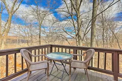 a table and two chairs sitting on a deck at Mountain Creek Condo with Grill Walk to Lifts! in Vernon