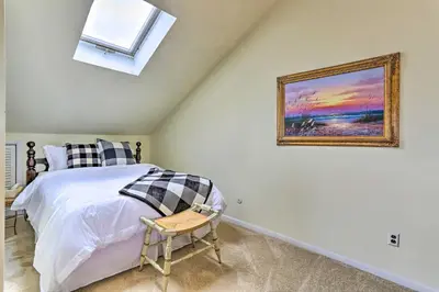 a bedroom with a bed and a painting on the wall at Mountain Creek Condo with Grill Walk to Lifts! in Vernon