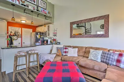 a living room with a couch and a table at Mountain Creek Condo with Grill Walk to Lifts! in Vernon