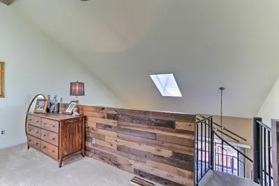 a room with a wooden wall and a dresser at Mountain Creek Condo with Grill Walk to Lifts! in Vernon