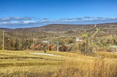 a field with a hill in the distance with at Mountain Creek Condo with Grill Walk to Lifts! in Vernon