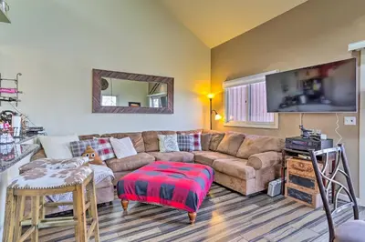 a living room with a couch and a flat screen tv at Mountain Creek Condo with Grill Walk to Lifts! in Vernon