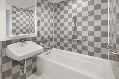 a bathroom with a sink and a bath tub at Best Western Premier Empire State Hotel in New York