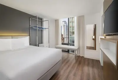a bedroom with a white bed and a large window at Best Western Premier Empire State Hotel in New York