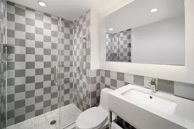 a bathroom with a sink and a toilet and a mirror at Best Western Premier Empire State Hotel in New York