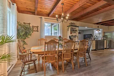 a dining room with a wooden table and chairs at Deck and Pool Access Welcoming Poconos Retreat in Tobyhanna