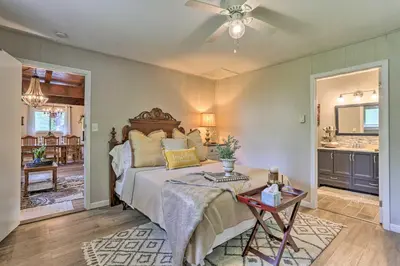 a bedroom with a large bed and a table at Deck and Pool Access Welcoming Poconos Retreat in Tobyhanna