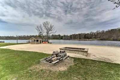 a bunch of rocks sitting on a bench next to a lake at Deck and Pool Access Welcoming Poconos Retreat in Tobyhanna