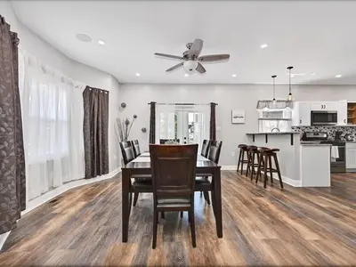 a dining room and kitchen with a table and chairs at 15min to Lincoln Ecuador vs Ivory Coast, Sleeps 12 in East Lansdowne