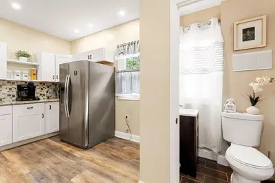 a kitchen with a stainless steel refrigerator and a toilet at 15min to Lincoln Ecuador vs Ivory Coast, Sleeps 12 in East Lansdowne