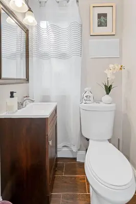 a bathroom with a white toilet and a sink at 15min to Lincoln Ecuador vs Ivory Coast, Sleeps 12 in East Lansdowne