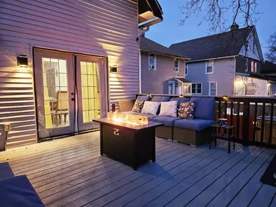 a patio with a couch and a table on a deck at 15min to Lincoln Ecuador vs Ivory Coast, Sleeps 12 in East Lansdowne