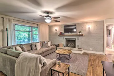 a living room with a couch and a fireplace at Sunroom, Fire Pit and Sauna Lake Locust Village Gem in Pocono Lake