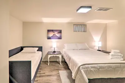 a room with two beds and a table with two lamps at Sunroom, Fire Pit and Sauna Lake Locust Village Gem in Pocono Lake