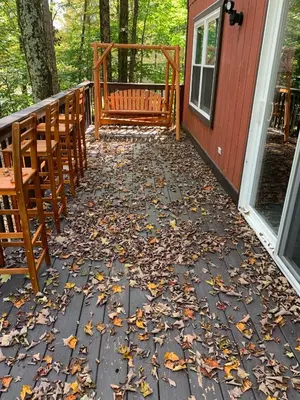 a porch with a bunch of leaves on the ground at Lakeview Cabin in The Hideout in Lake Ariel