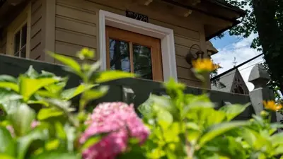 a house with a door and flowers in front of it at The Suite in a historic carriage house in Kennett Square