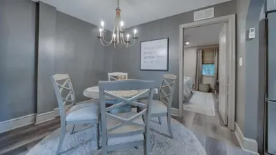 a dining room with a blue table and chairs at The Suite in a historic carriage house in Kennett Square