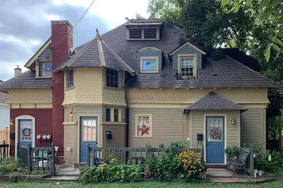 a large house with a blue door at The Suite in a historic carriage house in Kennett Square