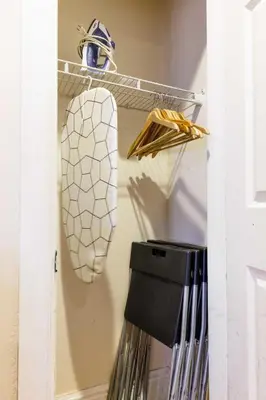 a closet with a white door and a shelf with clothes at Studios in New York in New York