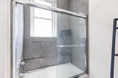 a glass shower door with a window in a bathroom at Studios in New York in New York