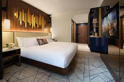a hotel room with a large bed and a desk at Hard Rock Hotel New York in New York